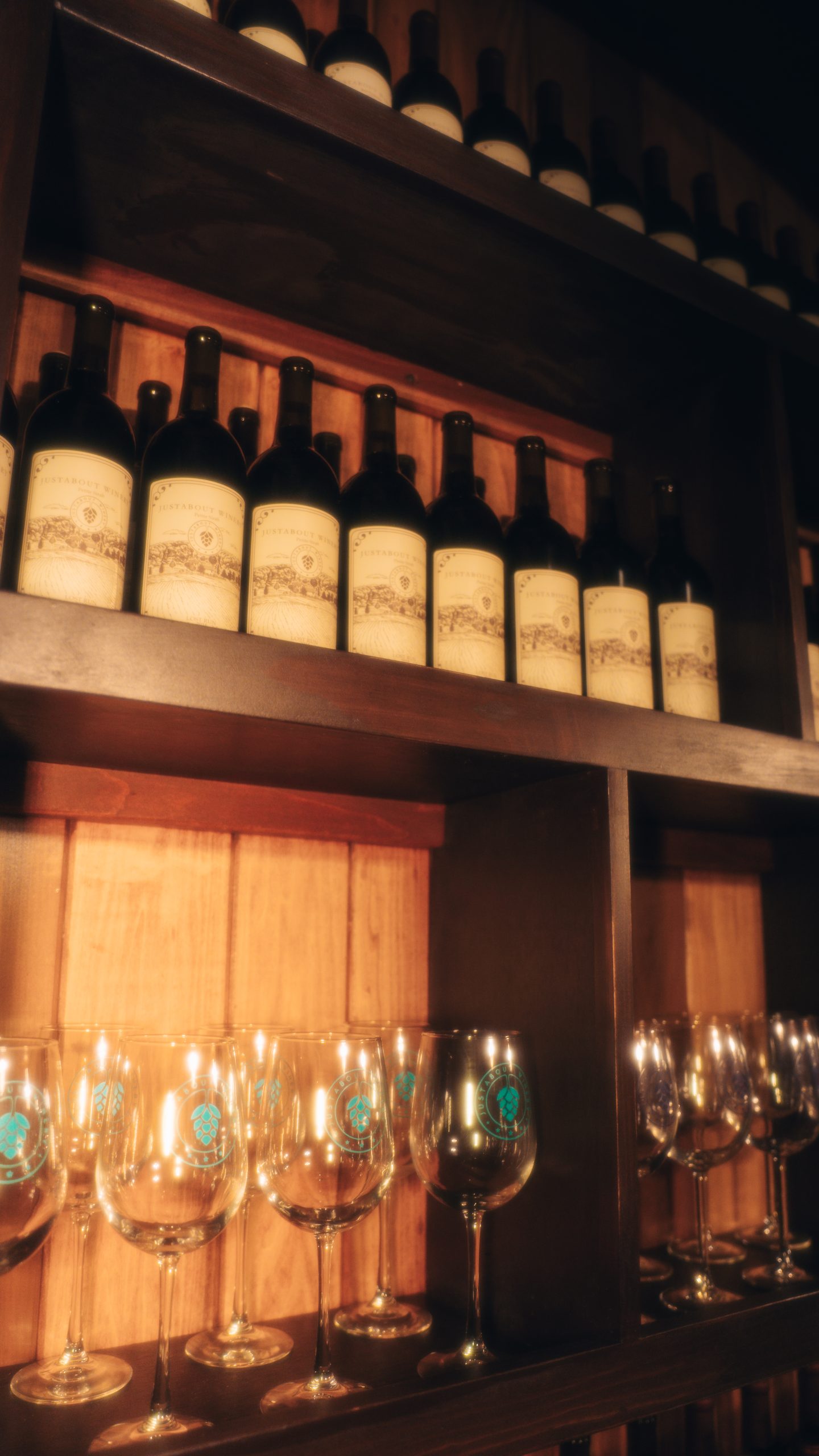 Wine bottles and glasses in winery